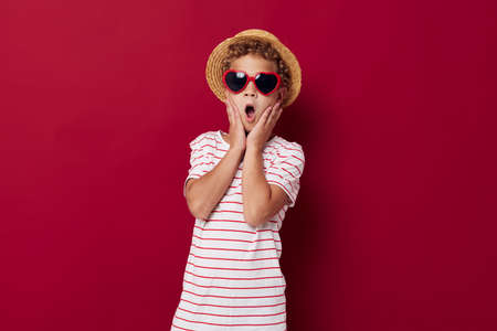 little boy wearing sunglasses and hat posing fashion childrens style