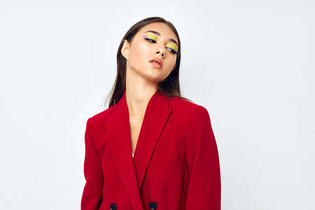 portrait pretty woman in a red jacket cosmetics smile light background unalteredの写真素材