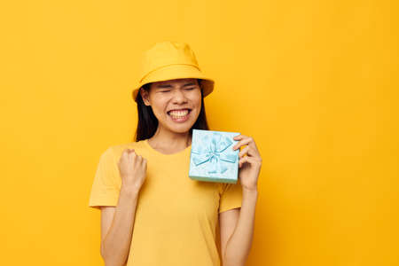 Portrait Asian beautiful young woman with a gift box in his hands surprise emotions Lifestyle unalteredの写真素材