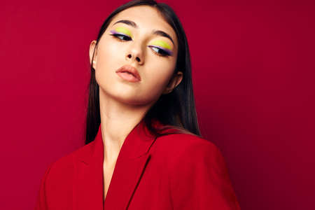 beautiful brunette fashion posing in red jacket isolated background unalteredの写真素材