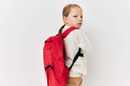 little girl red backpack stylish clothes isolated backgroundの写真素材