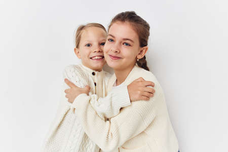 two little girls girlfriends posing light background