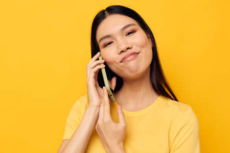 Charming young Asian woman phone communication fun use Lifestyle unaltered