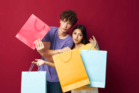 cute young couple colorful bags shopping fun isolated background unaltered