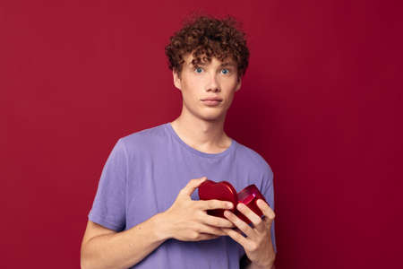 cute red-haired guy heart in hands gift romance