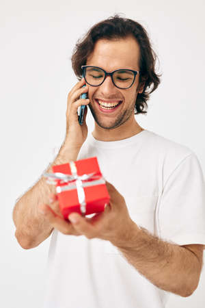 Attractive man Red gift box telephone communication isolated background