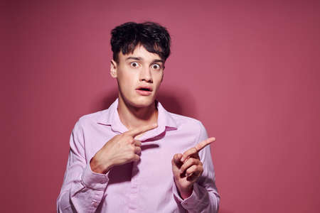 portrait of a young man posing fashion pink shirt modern style pink background unaltered