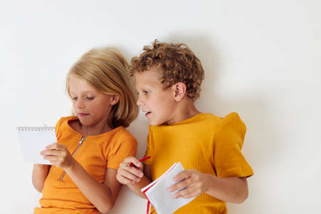 picture of positive boy and girl drawing fun games with notepad childhood lifestyle unalteredの写真素材