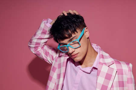 handsome guy fashionable glasses pink blazer posing studio model studio