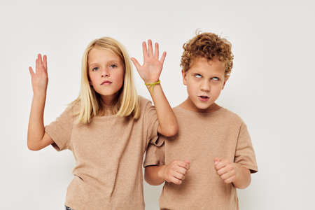 Boy and girl gesticulate with their hands together childhood unalteredの写真素材