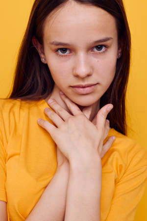 optimistic young woman fashion in yellow t-shirt denim shorts isolated background