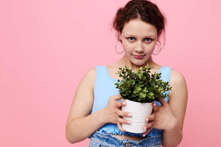 funny girl flower in white pot posing emotion isolated backgrounds unalteredの写真素材