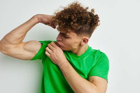 kinky guy in green t-shirts emotions posing isolated backgroundの写真素材