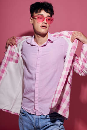 Photo of romantic young boyfriend self confidence pink plaid blazer fashion posing pink background unalteredの写真素材