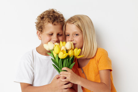 cheerful children fun birthday gift surprise bouquet of flowers isolated background unaltered