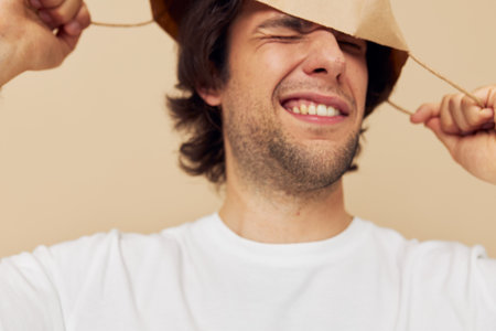 Attractive man in a white T-shirt with paper bag isolated backgroundの写真素材