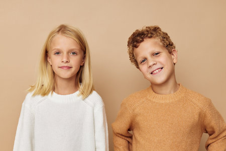 Little boy and girl in sweaters together fun childhood unalteredの写真素材
