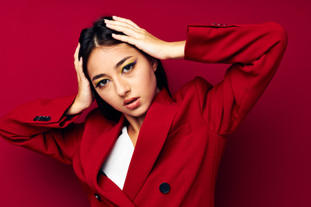 beautiful brunette attractive look glamor cosmetics fashion red background unalteredの写真素材