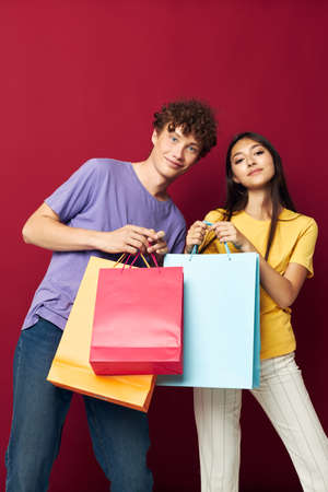 teenagers colorful bags shopping fun red background unaltered