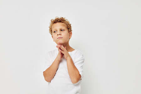 Photo of young boy smile in white t-shirt isolated background