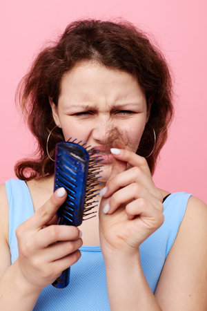 portrait of a woman removes hair on a comb dissatisfaction Lifestyle unaltered