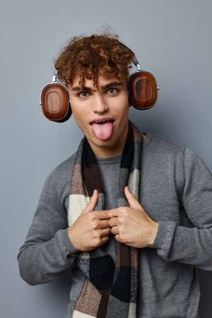 handsome young man elegant style checkered scarf headphones isolated background