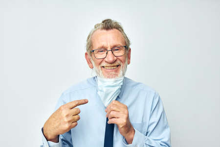 elderly man in shirt with tie medical mask safety isolated backgroundの写真素材
