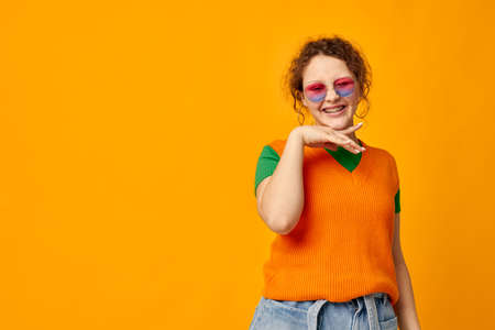 funny girl multicolored sunglasses on face posing grimace cropped view unaltered