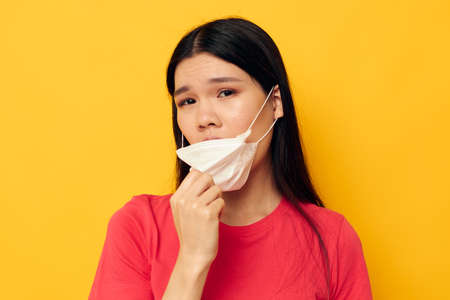 pretty brunette posing medical mask close-up isolated background unaltered