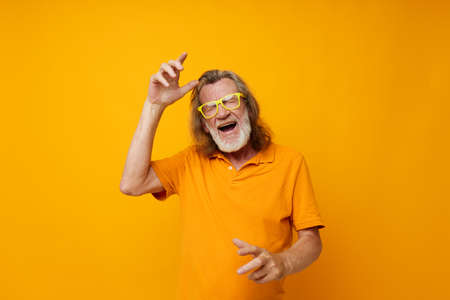old man in yellow glasses with a gray beard emotions monochrome shot