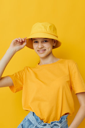 beautiful girl in a yellow t-shirt and Hat emotions summer style isolated backgroundの写真素材