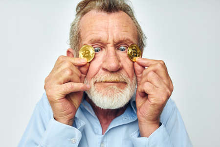 Portrait elderly man cryptocurrency bitcoin face close up investment unaltered