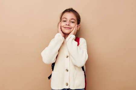 Portrait of happy smiling child girl schoolgirl backpack school childhood unaltered
