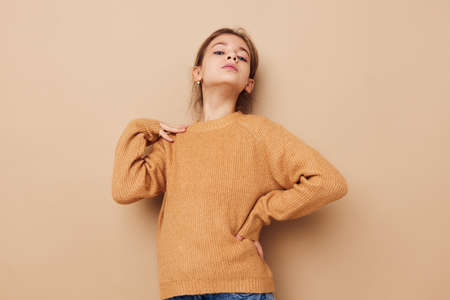 cute girl in sweater posing hand gestures isolated backgroundの写真素材