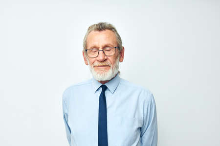 elderly man with gray beard in business office suitの写真素材