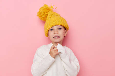 Portrait of happy smiling child girl in a sweater and a hat childhood unalteredの写真素材