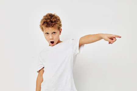 curly boy smile in white t-shirt isolated background