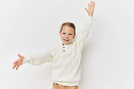 Portrait of happy smiling child girl baby clothes fashion light background