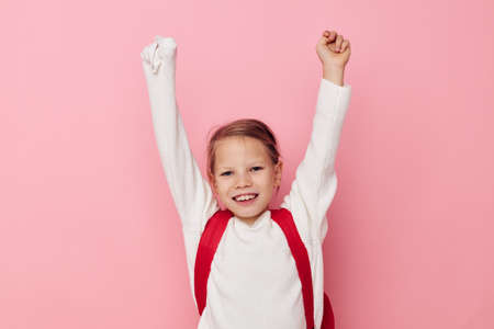 Portrait of happy smiling child girl kids style backpack school isolated backgroundの写真素材