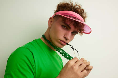 handsome young man green t-shirt decoration fashion glasses Lifestyle unalteredの写真素材