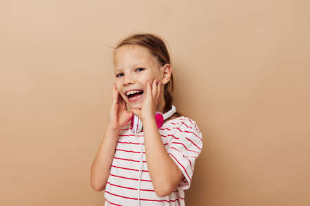 little girl in striped t-shirt headphones gesture hands childhood unaltered