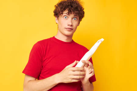 cute red-haired guy detergents home care posing isolated background unaltered