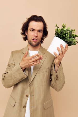 handsome man with a flower pot in his hands classic style isolated background