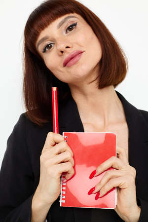 attractive woman short haired red notepad and pencil isolated background