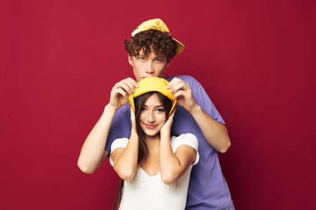 nice guy and girl stand side by side fashion modern style home fun red backgroundの写真素材