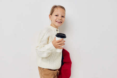 cute girl school backpack with a hat on his head isolated backgroundの写真素材