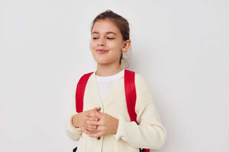 pretty young girl hand gesture red backpack childhood unalteredの写真素材