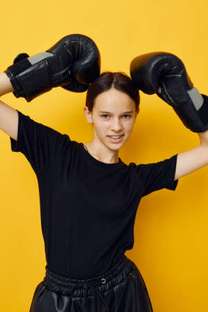 photo pretty girl black boxing gloves posing isolated background