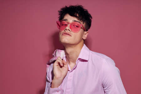 portrait of a young man pink shirt and glasses jacket fashion elegant style isolated background...