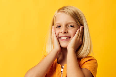 joyful girl with blond hair gesturing with her hands